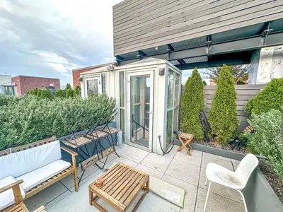 a patio with a bench and a table and chairs at Penthouse in Greenpoint in Brooklyn