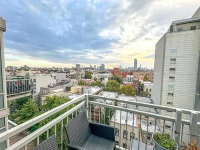 an apartment balcony with a view of a city at Penthouse in Greenpoint in Brooklyn