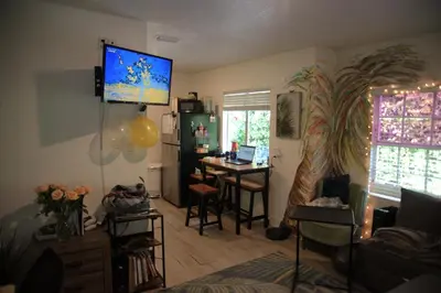 a living room with a table and a desk at STUDIO IN LIC WITH POOL AnD VIEW in Roosevelt Island