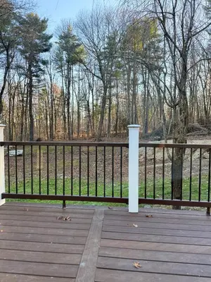 a wooden bench on a wooden deck with a fence at King Cabin