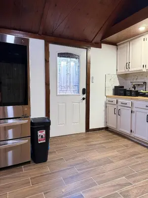a kitchen with a white door and a window at King Cabin