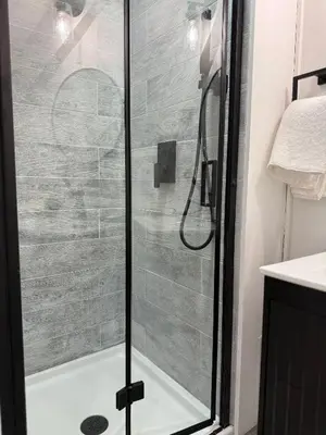 a shower with a glass door in a bathroom at King Cabin