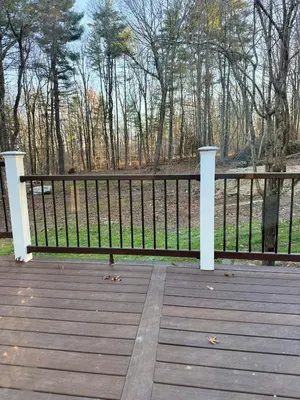 a bench on a wooden deck with a fence at King Cabin