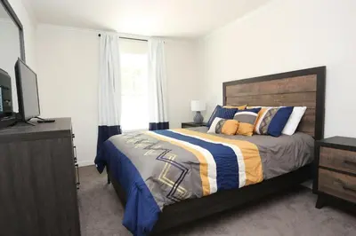 a bedroom with a bed and a television in it at Oneonta Hideaway in Oneonta