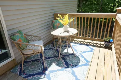 a patio with a table and two chairs on a porch at Oneonta Hideaway in Oneonta