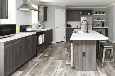a kitchen with brown cabinets and a white counter top at Oneonta Hideaway in Oneonta