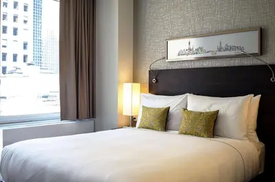 a bedroom with a large white bed with a window at The Bernic Hotel New York City,Tapestry Collection by Hilton in New York