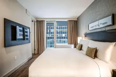 a large white bed in a room with a window at The Bernic Hotel New York City,Tapestry Collection by Hilton in New York
