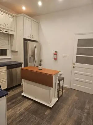 a kitchen with a island in the middle of it at Cozy Getaway 3-Prudential Center, NJPAC, Penn Station in Kearny