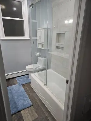 a bathroom with a glass shower and a toilet at Cozy Getaway 3-Prudential Center, NJPAC, Penn Station in Kearny