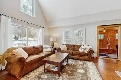 a living room with a couch and a table at Buckboard Haven in Dover