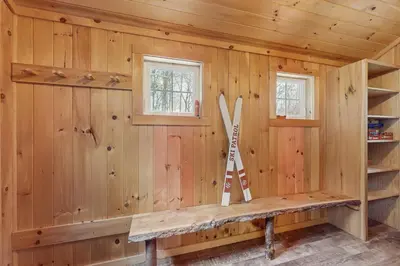 a log cabin with two skis on the wall at Buckboard Haven in Dover