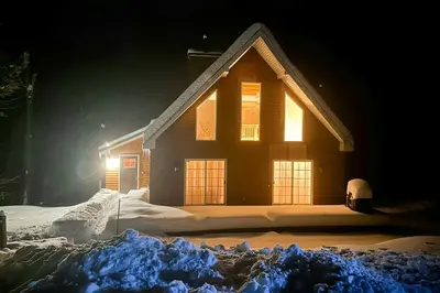 a house covered in snow at night at Buckboard Haven in Dover