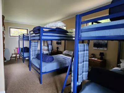 a bedroom with two bunk beds with blue bunkitures at Stunning Views from the Fire Tower Cabin in Cambridge