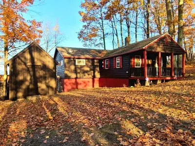 a small house in the middle of a yard at Stunning Views from the Fire Tower Cabin in Cambridge