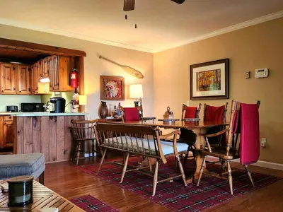 a living room with a wooden table and chairs at Stunning Views from the Fire Tower Cabin in Cambridge