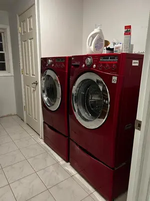 a red washer and dryer in a room at Spacious 4BR Retreat Yard, BBQ & Prime Location in Clifton Park