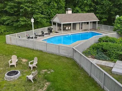 a fence around a swimming pool in a yard at Large Villa 5 Beds, 3 Baths, Firepit, Cozy Stay in Fort Edward