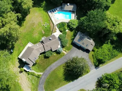an aerial view of a house with a swimming pool at Large Villa 5 Beds, 3 Baths, Firepit, Cozy Stay in Fort Edward
