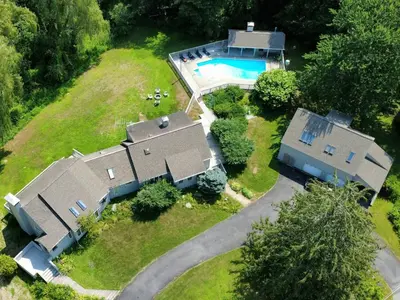 an aerial view of a house with a swimming pool at Large Villa 5 Beds, 3 Baths, Firepit, Cozy Stay in Fort Edward