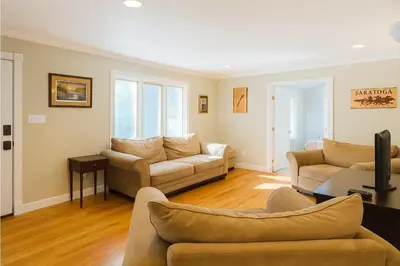 a living room with two couches and a tv at Large Villa 5 Beds, 3 Baths, Firepit, Cozy Stay in Fort Edward