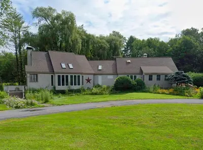 a large white house with a gambrel roof at Large Villa 5 Beds, 3 Baths, Firepit, Cozy Stay in Fort Edward