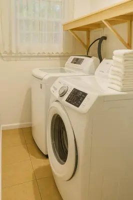 a white washer and dryer in a laundry room at Best house in town in Latham
