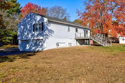 a large white house with a yard in front of it at Pet-Friendly Saratoga Home with Fire Pit & Deck in Saratoga Springs