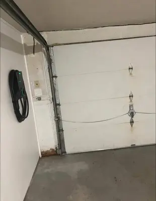a garage with a white garage door with two lights at Pet-Friendly Saratoga Home with Fire Pit & Deck in Saratoga Springs
