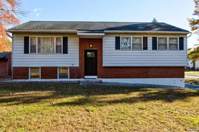 a house with a red brick at Pet-Friendly Saratoga Home with Fire Pit & Deck in Saratoga Springs