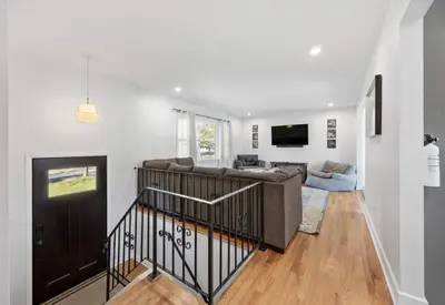 a living room with a couch and a tv at Pet-Friendly Saratoga Home with Fire Pit & Deck in Saratoga Springs