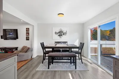 a kitchen and dining room with a table and chairs at Pet-Friendly Saratoga Home with Fire Pit & Deck in Saratoga Springs