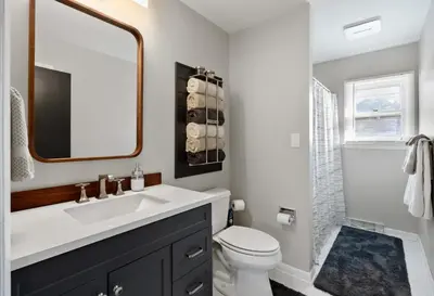 a bathroom with a sink and a toilet and a mirror at Pet-Friendly Saratoga Home with Fire Pit & Deck in Saratoga Springs