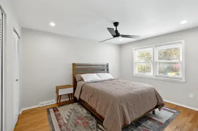 a bedroom with a bed and a ceiling fan at Pet-Friendly Saratoga Home with Fire Pit & Deck in Saratoga Springs