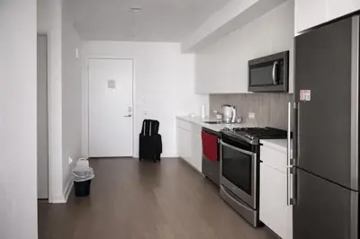 a kitchen with a stove and a refrigerator at Elegant Long Island City Studio with Skyline Views in Roosevelt Island