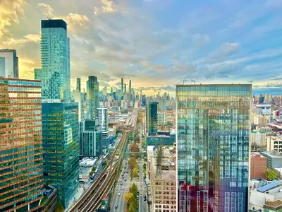 a view of a city with many tall buildings at Elegant Long Island City Studio with Skyline Views in Roosevelt Island