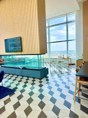 a large room with a fish tank in the middle at Elegant Long Island City Studio with Skyline Views in Roosevelt Island