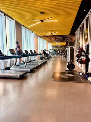 a gym with a man running on treadles in a gym at Elegant Long Island City Studio with Skyline Views in Roosevelt Island