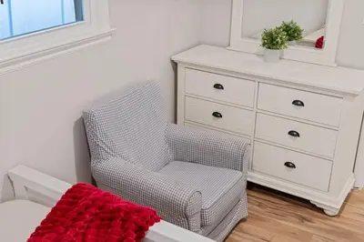 a bedroom with a chair and a dresser at 3BR Home 2 Baths Bonus Room, Minutes to NYC in Hackensack
