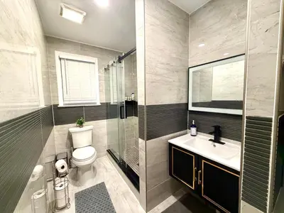 a bathroom with a toilet and a sink and a shower at 3BR Home 2 Baths Bonus Room, Minutes to NYC in Hackensack