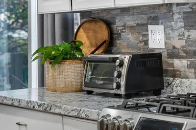 a kitchen counter with a toaster oven and a plant at 4BR Home Minutes to NYC Time Square in Teaneck
