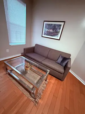a living room with a couch and a coffee table at Eagle Pamir Guest House in New Haven
