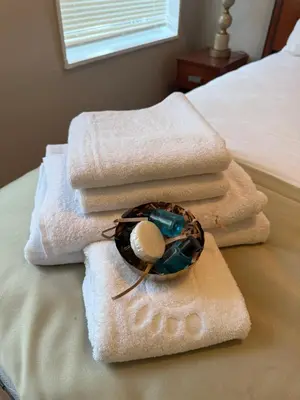 a pile of towels sitting on top of a bed at Eagle Pamir Guest House in New Haven