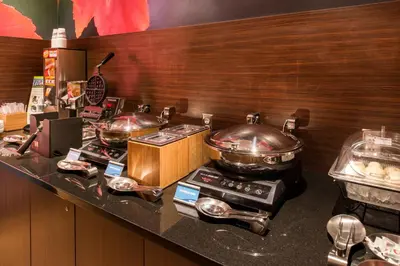 a kitchen with two pots and pans on a stove at Fairfield Inn & Suites by Marriott Utica in Utica