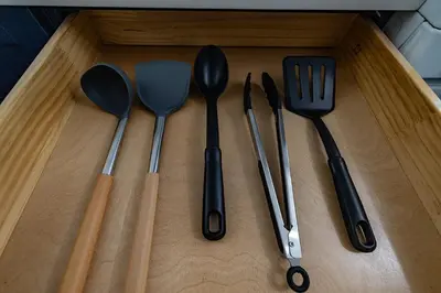 a group of utensils sitting on top of a wooden table at Cozy Urban Oasis Near NYC in West New York