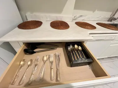 a drawer with silver utensils in a kitchen at Home in West Haven