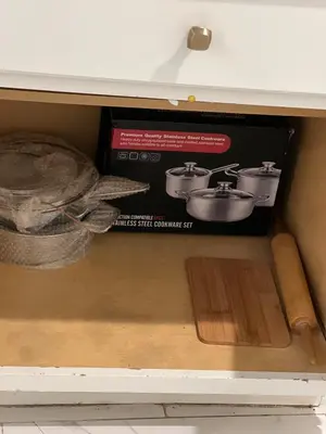 a box in a drawer with a knife and a pan at Home in West Haven