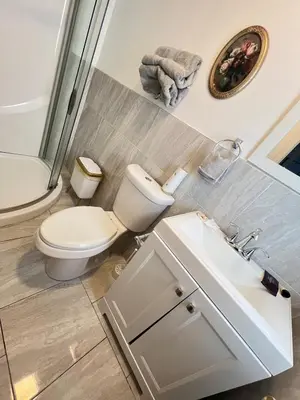 a bathroom with a toilet and a sink at Home in West Haven