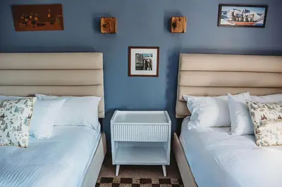 two beds sitting next to each other in a bedroom at Hideaway Inn Mt Snow in Dover
