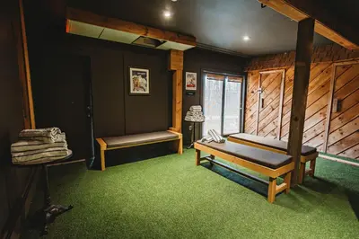 a bedroom with a bed and green carpet at Hideaway Inn Mt Snow in Dover